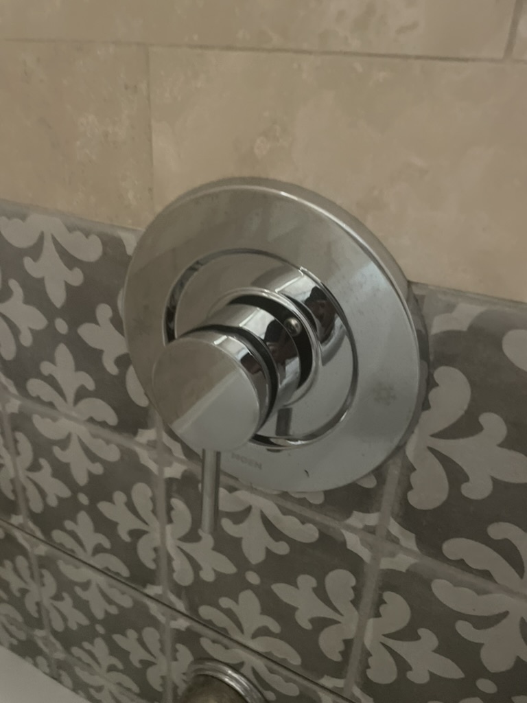 Cleanly installed chrome shower valve — finished work