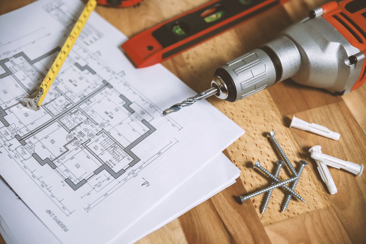 Architect reviewing construction drawings for new build plumbing