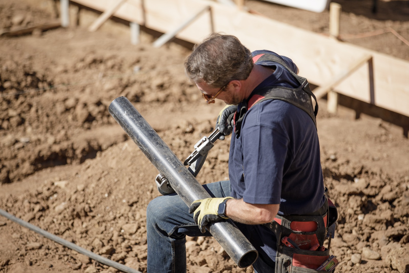 Joe carrying a run of main line across a job site