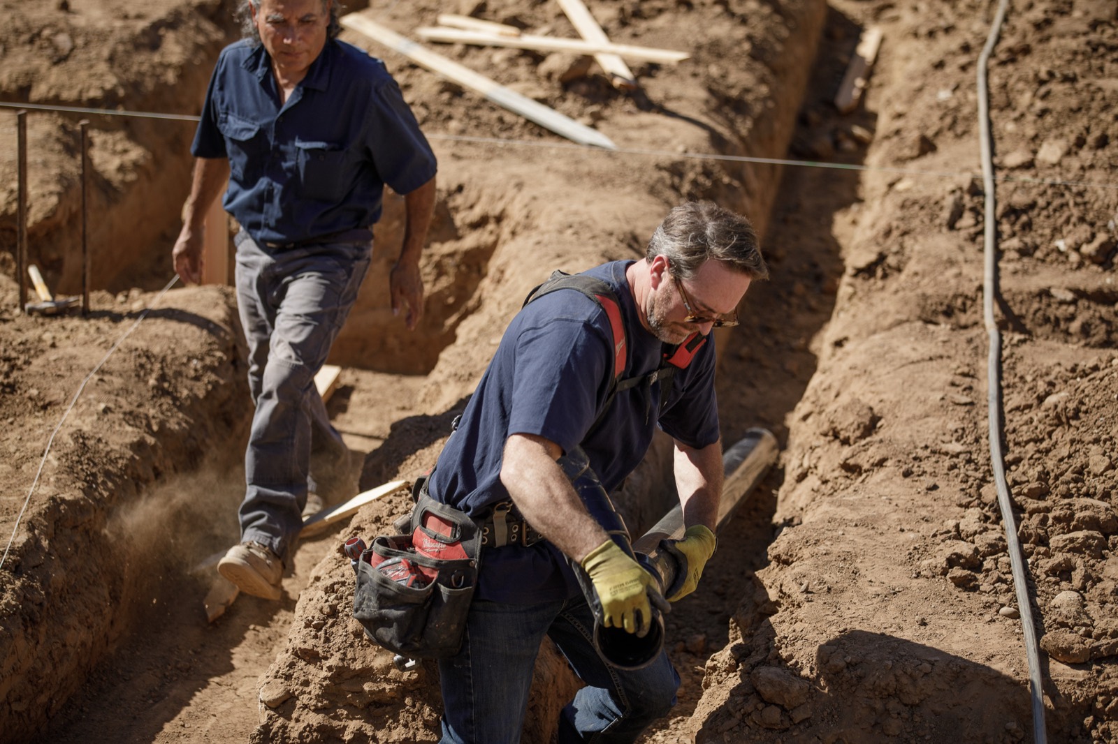 Joe roughing in underground drain lines on a Santa Barbara build