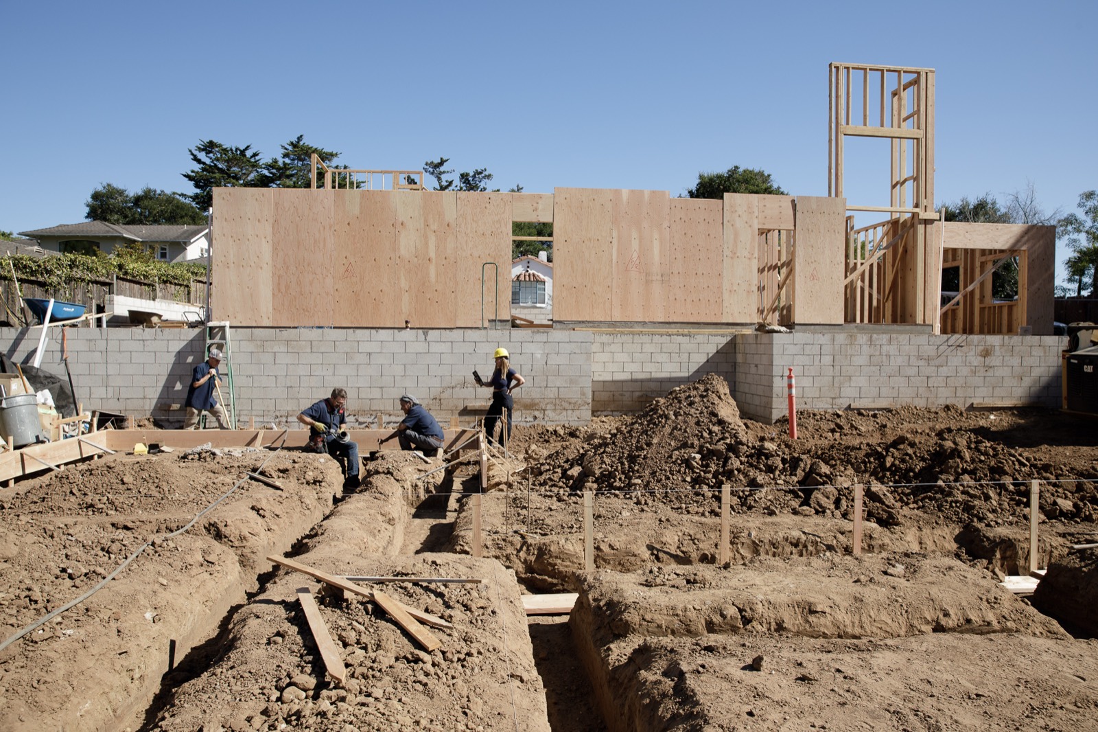 New-construction site with underground plumbing roughed in ahead of the slab
