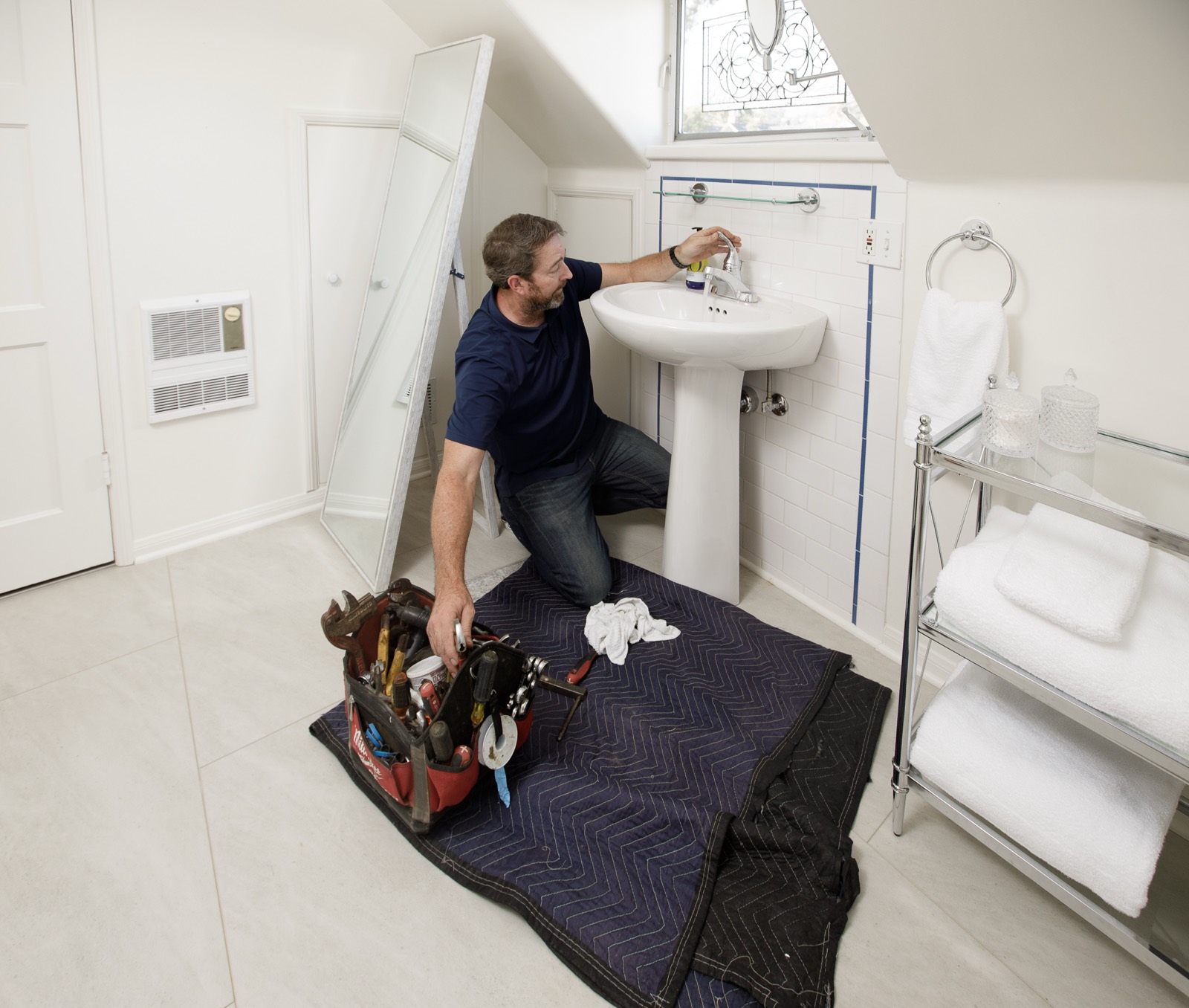 Joe servicing a pedestal sink during a scheduled maintenance visit
